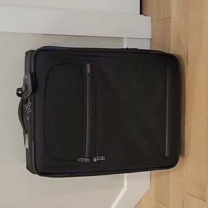 Tumi black rolling bag